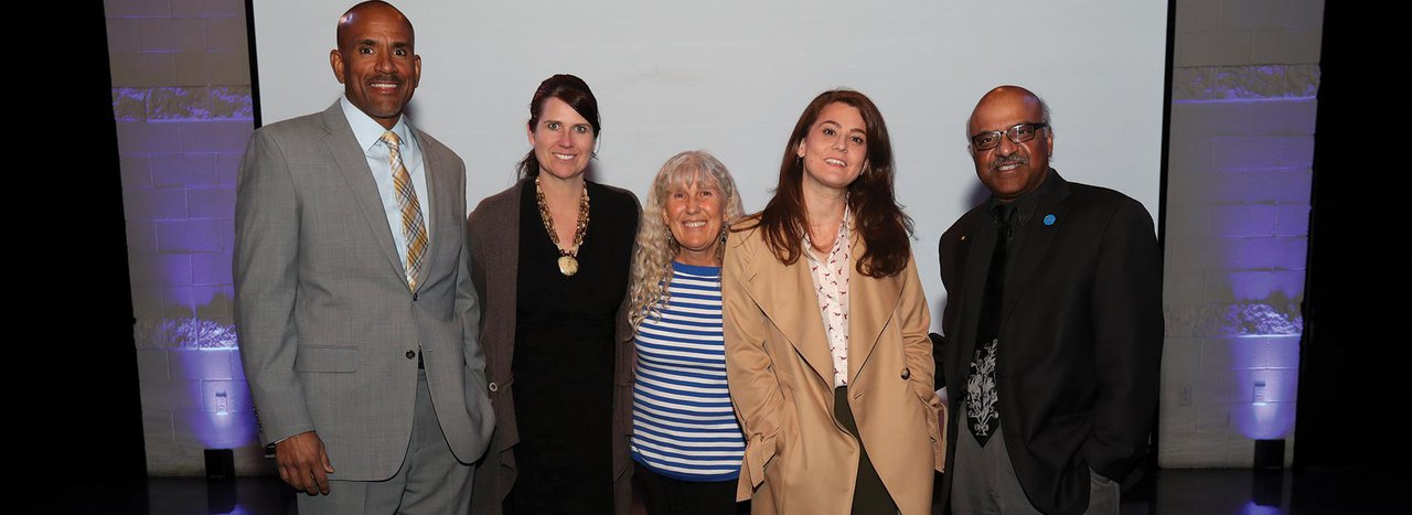 Group of featured speakers on presentation floor