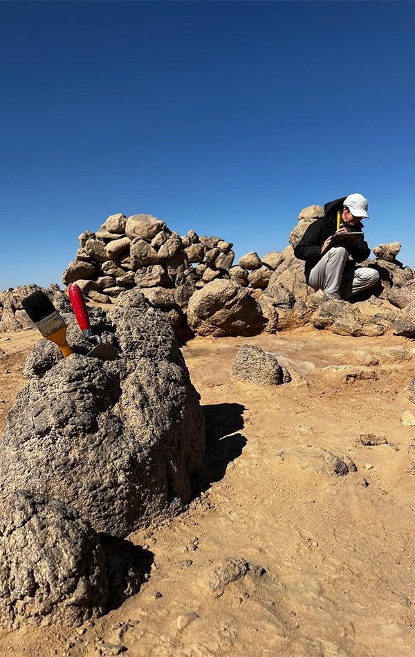 Student working at Wadi el-Hudi expedition site.