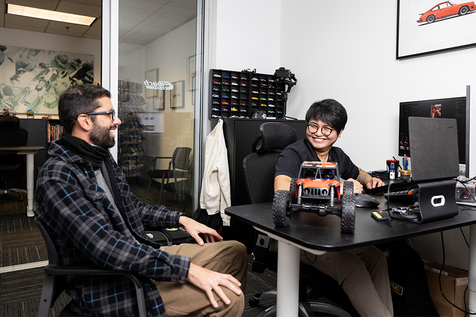 Santiago at computer with colleague