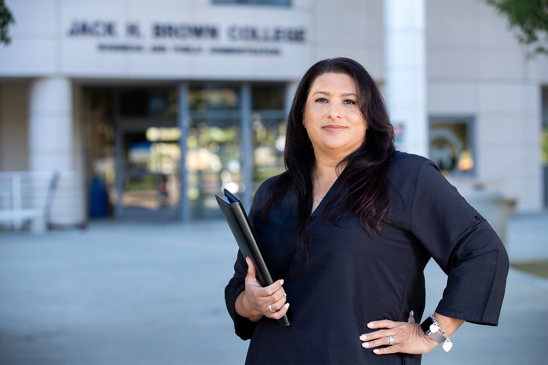 Angelica Agudo in front of Jack H. Brown College