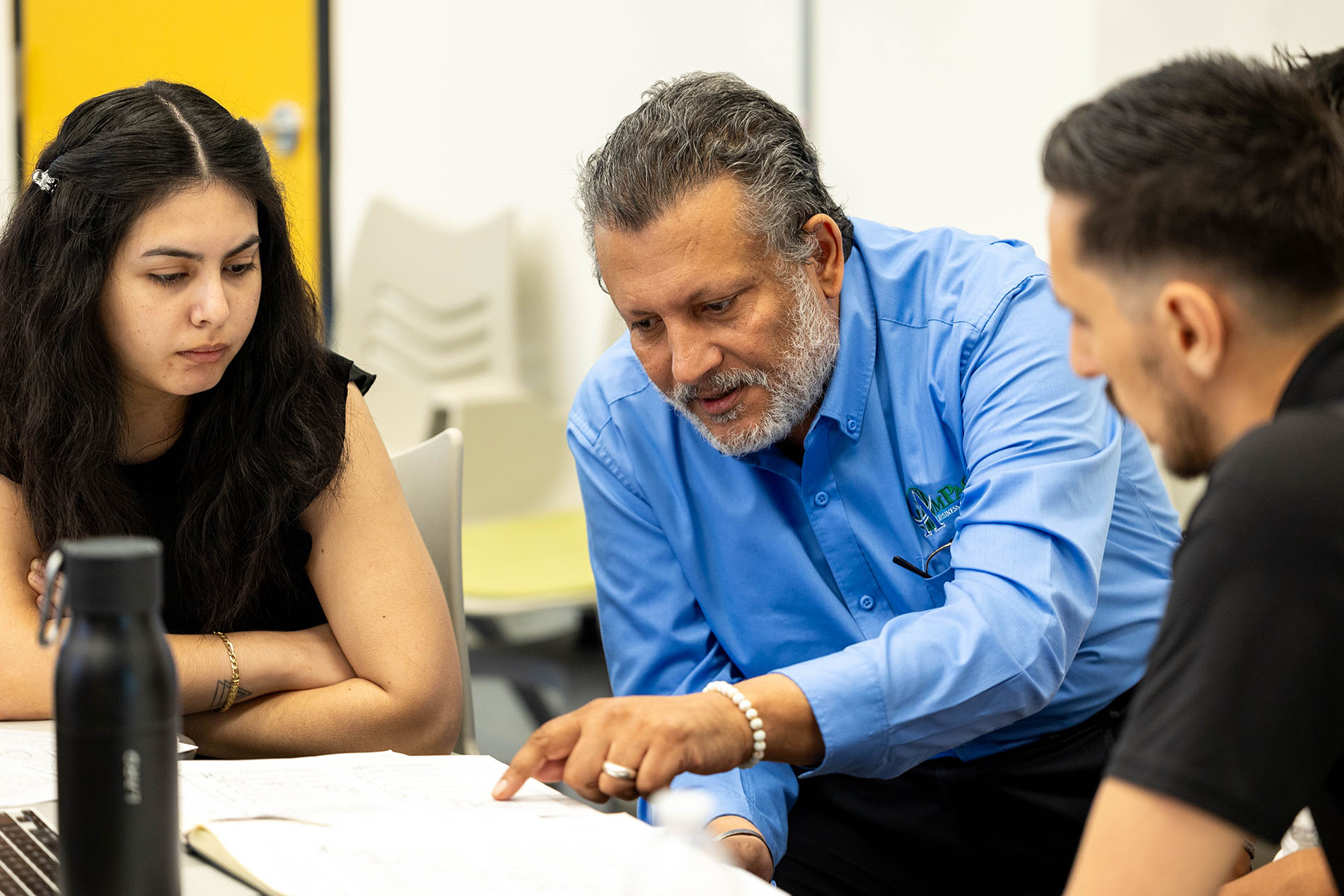 Professor helping students with an assignment