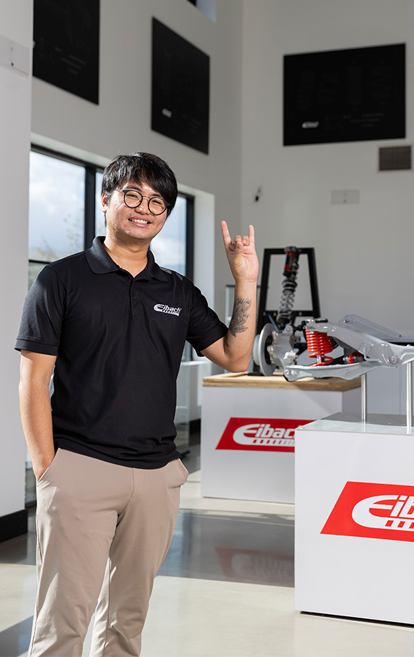 Santiago standing in showroom coyote sign