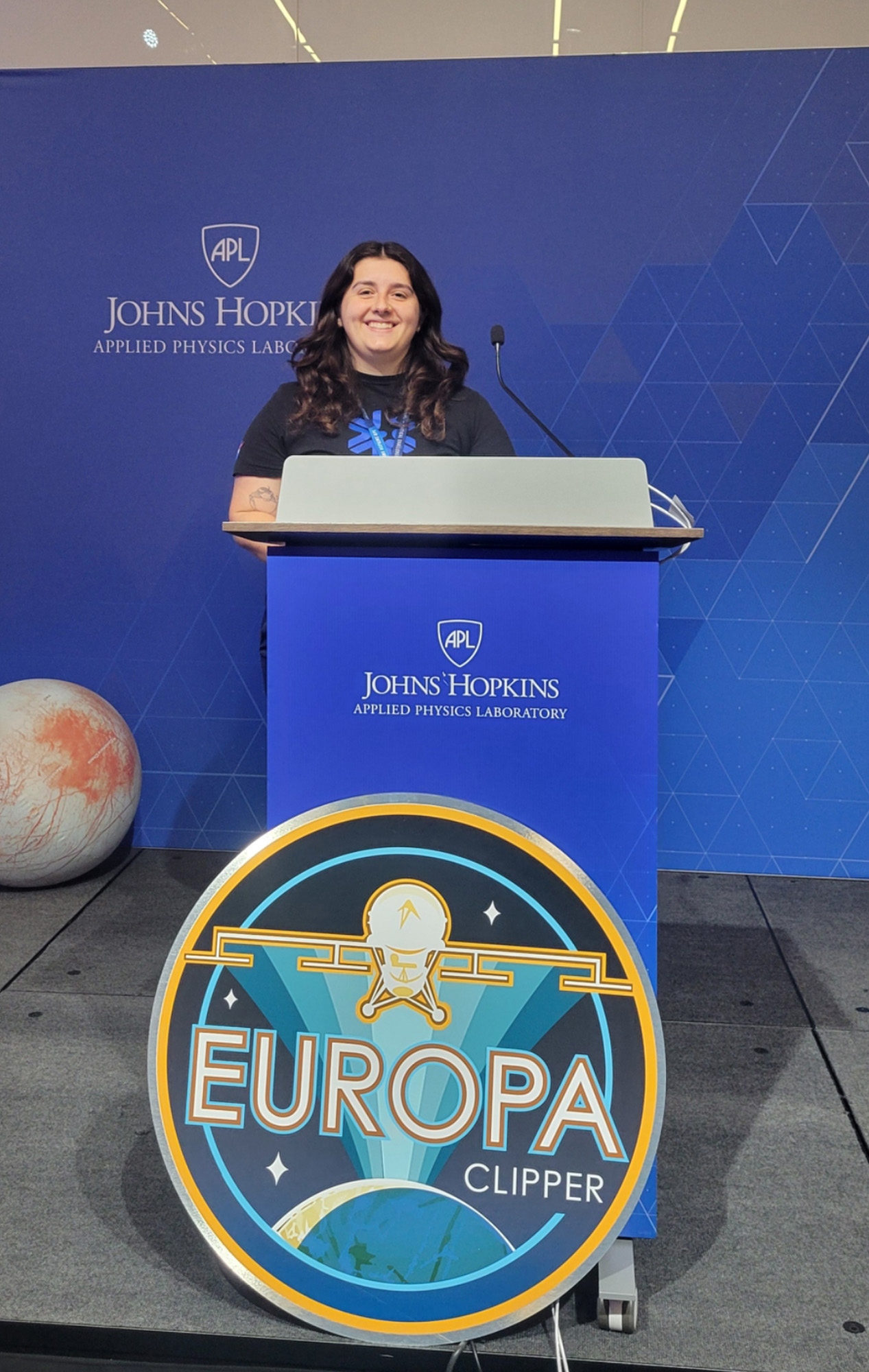 Emily Bridges speaking at podium