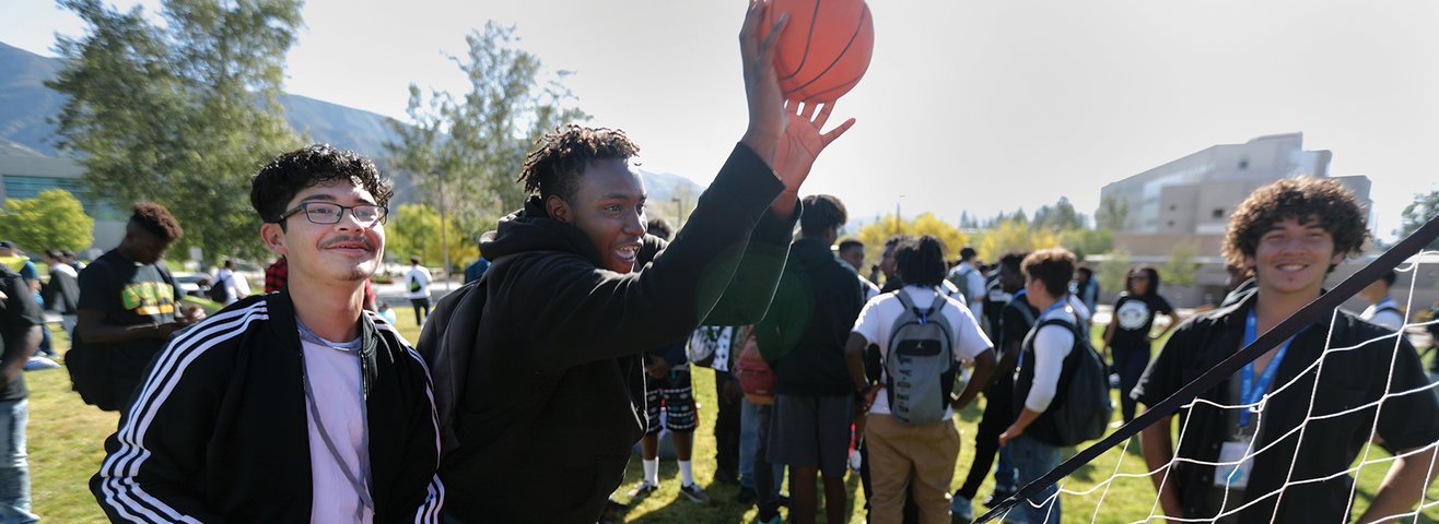 Young black and brown students play basketball during the Black and Brown conference. 