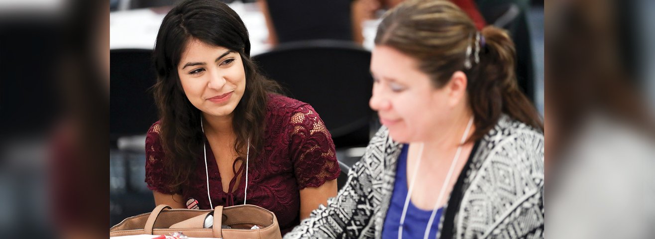 Two women in attendance at the Women’s Leadership Conference. 