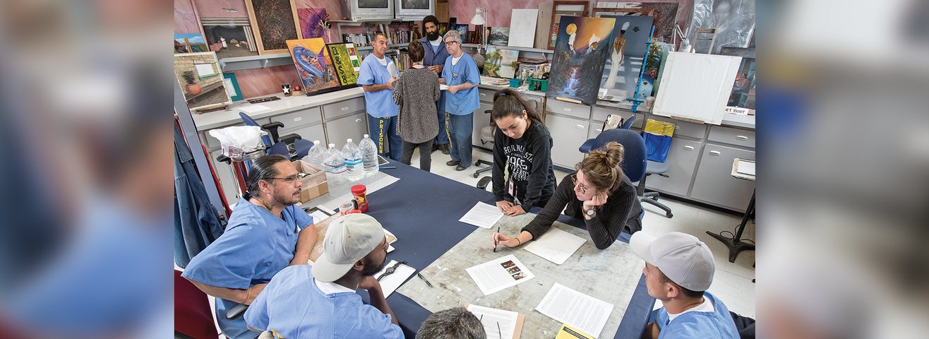 Students work with prisoners on art projects. 